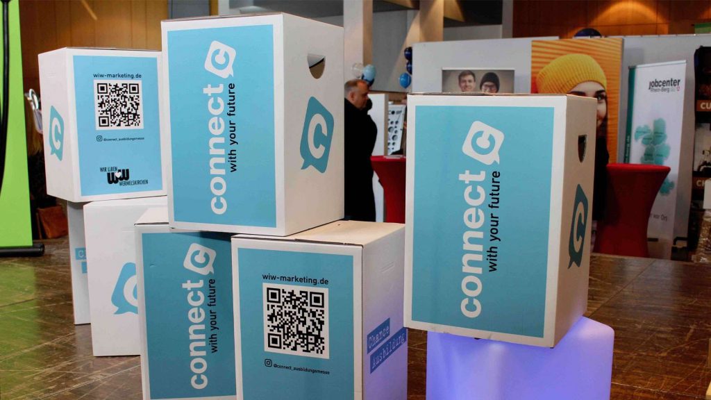 Gestapelte Kartons mit Connect-Logo und QR-Code
